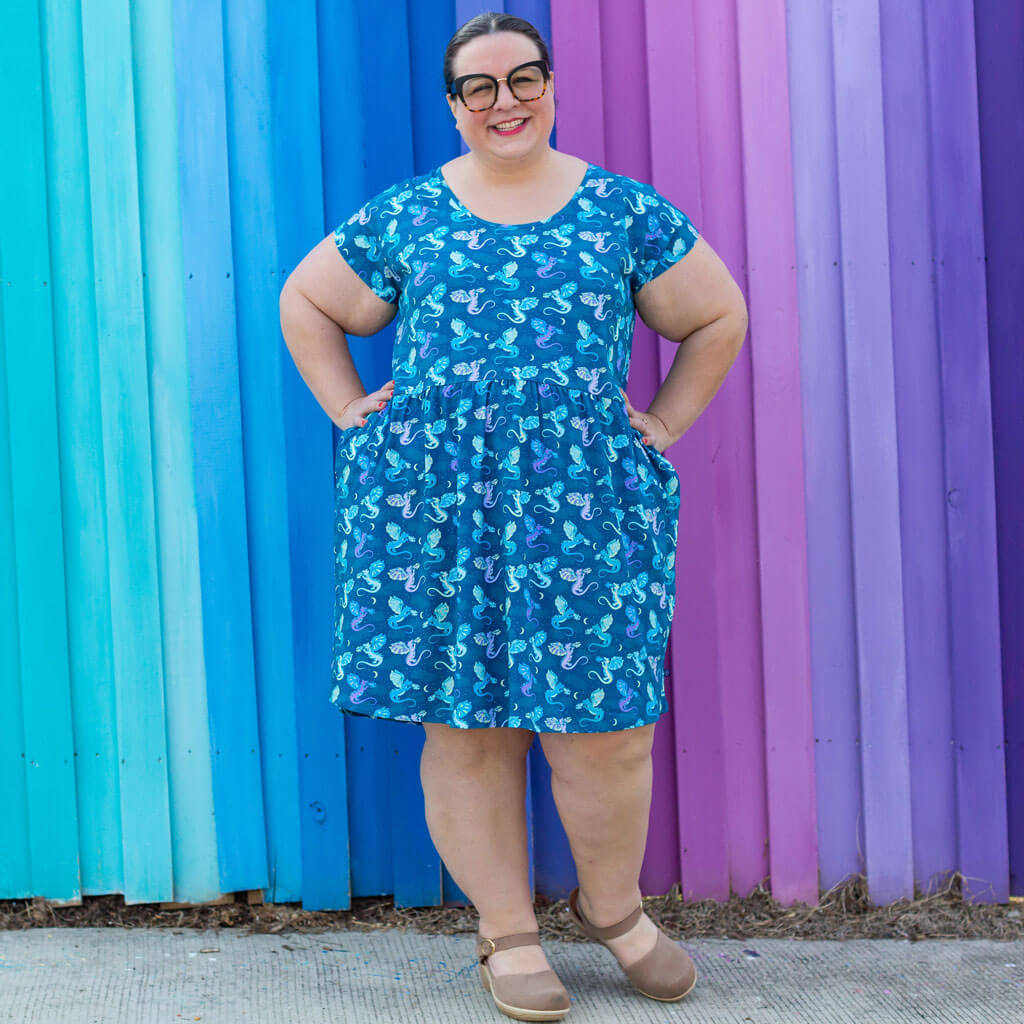 Princess Awesome & Boy Wonder Adult "Slay All Day" Dragons Cap Sleeve Dress with Pockets — Princess Awesome & Boy Wonder branding close-up