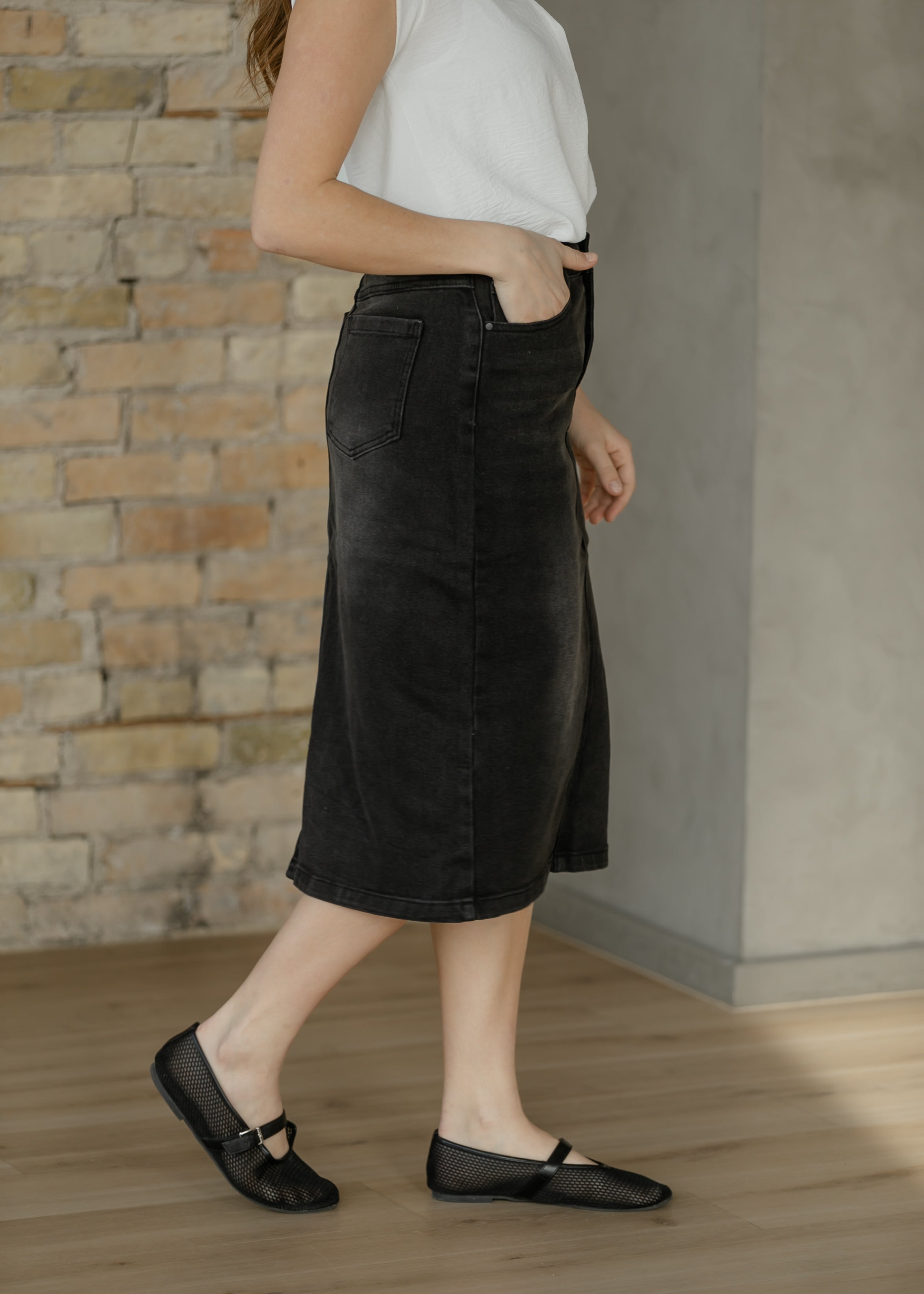 Inherit Co. Tiffany Black Denim Midi Skirt — in-use photo