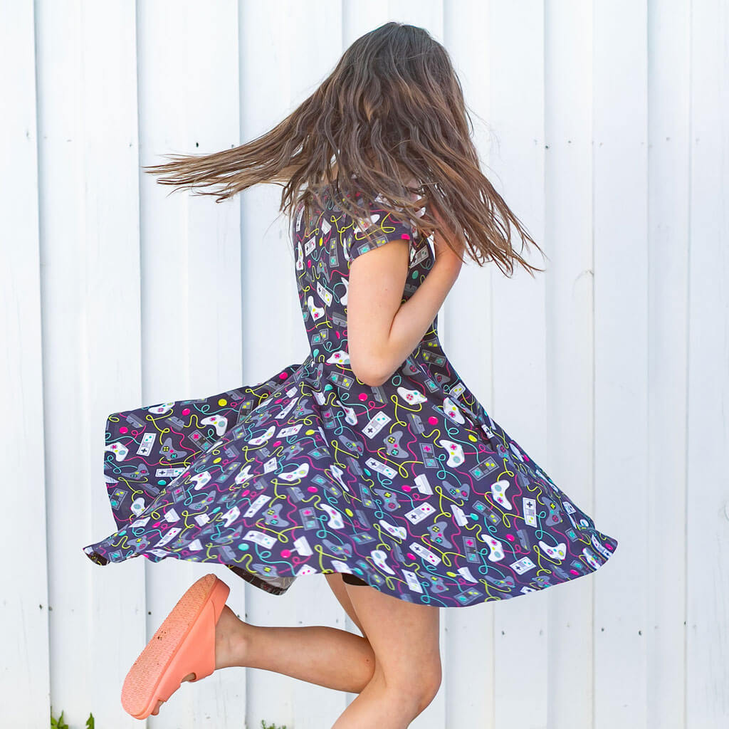 Princess Awesome & Boy Wonder Video Game Controllers Super Twirler Dress with Pockets — Princess Awesome & Boy Wonder branding close-up