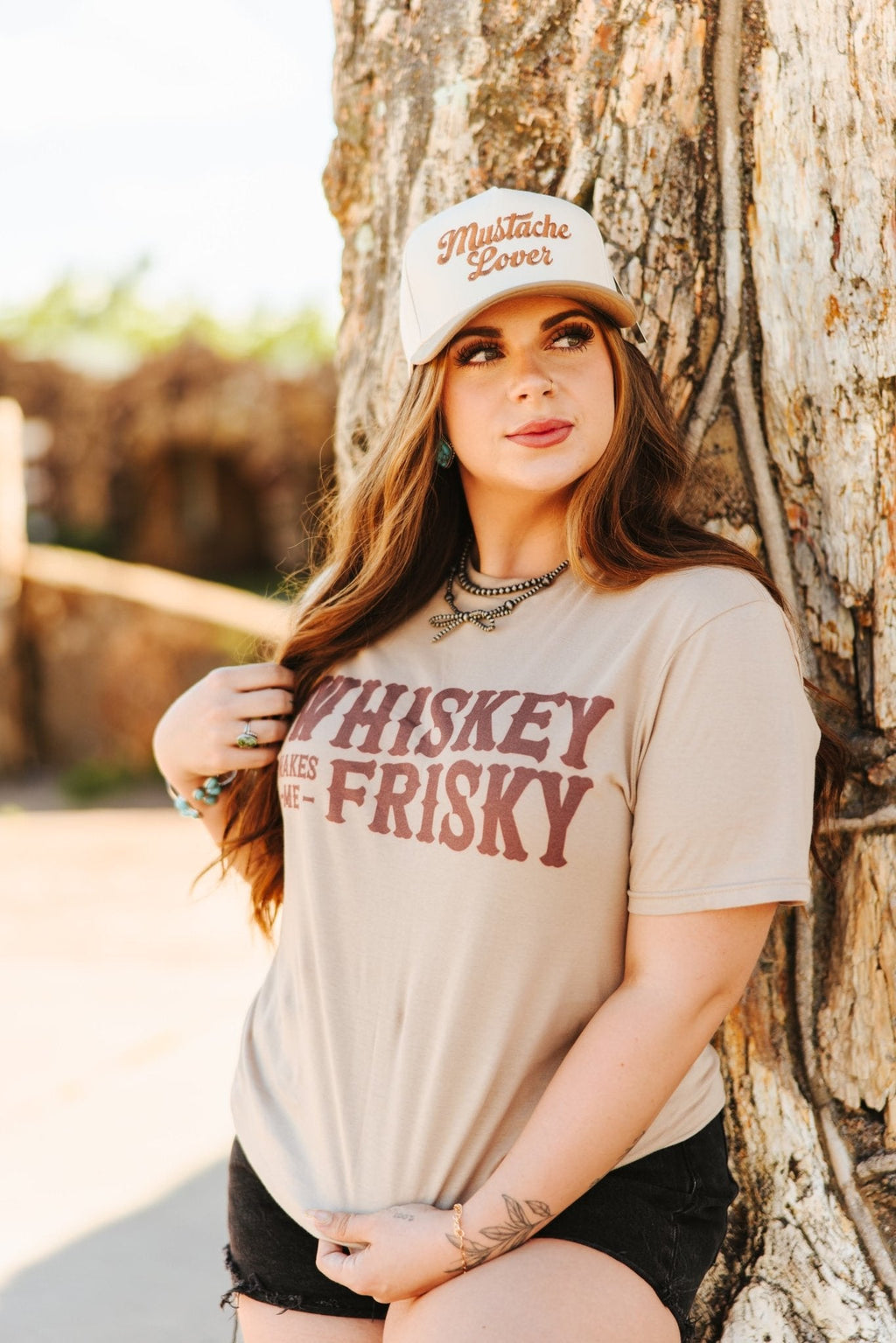 Wild Junkie Whiskey Makes Me Frisky Graphic Tee — lifestyle worn / used context