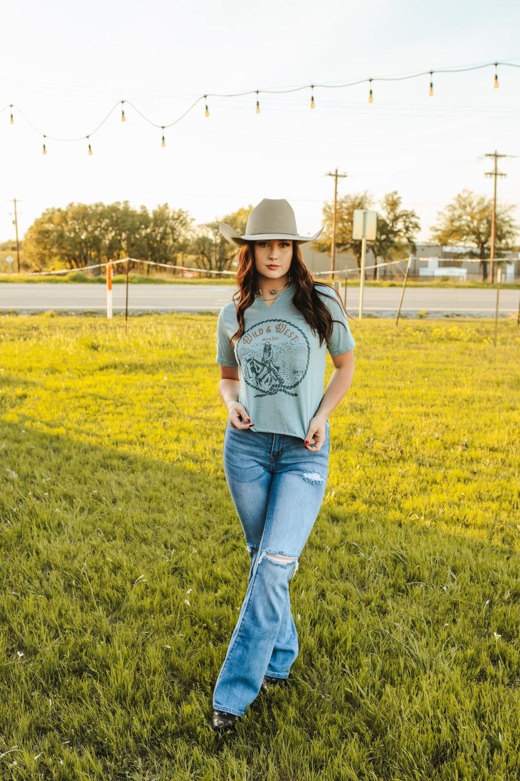 Wild Junkie Wild & West Raw Cut Hem and V-neck Graphic Tee — Wild Junkie branding close-up
